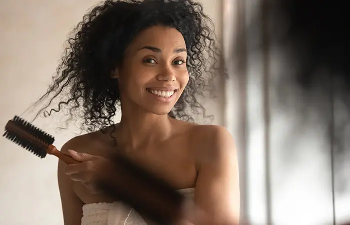 Woman prepping her hair before box braiding it