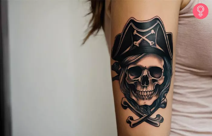 A woman with a pirate skull and crossbones tattoo on her arm