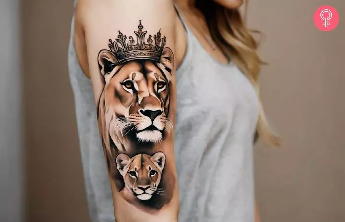Queen lioness and cub tattoo on the upper arm
