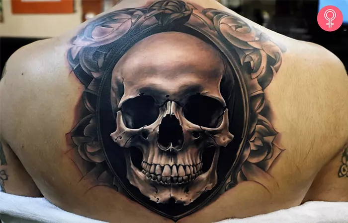 Realistic skull tattoo on the back of a man