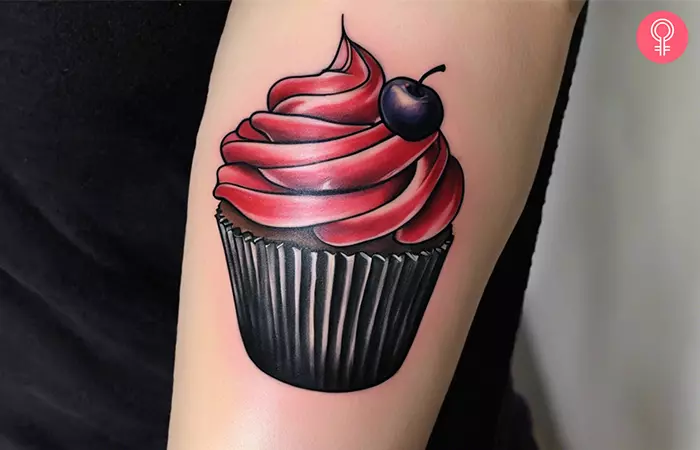 Realistic cupcake tattoo on the upper arm