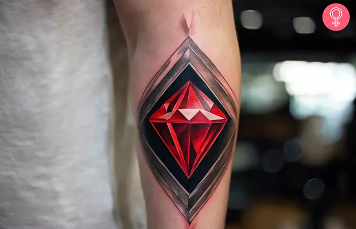 A man with a red diamond tattoo on his forearm