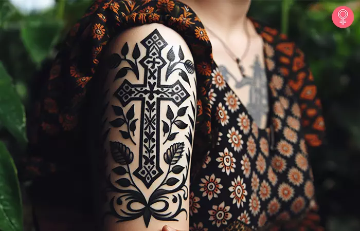 A woman wearing a religious quarter sleeve tattoo