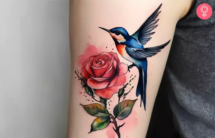Rose and swallow tattoo on the upper arm