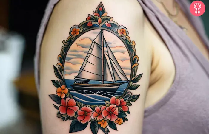 Woman with sailboat tattoo with flowers on her shoulder