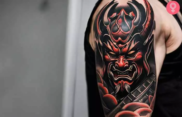 A man with a samurai Oni mask tattoo on his upper arm