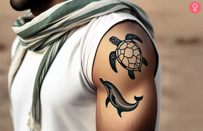 Sea turtle and dolphin tattoo on the upper arm