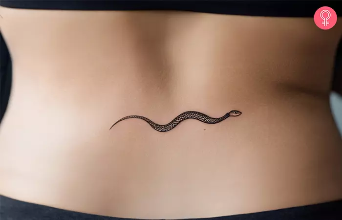 A woman with a serpent tattoo on her lower back