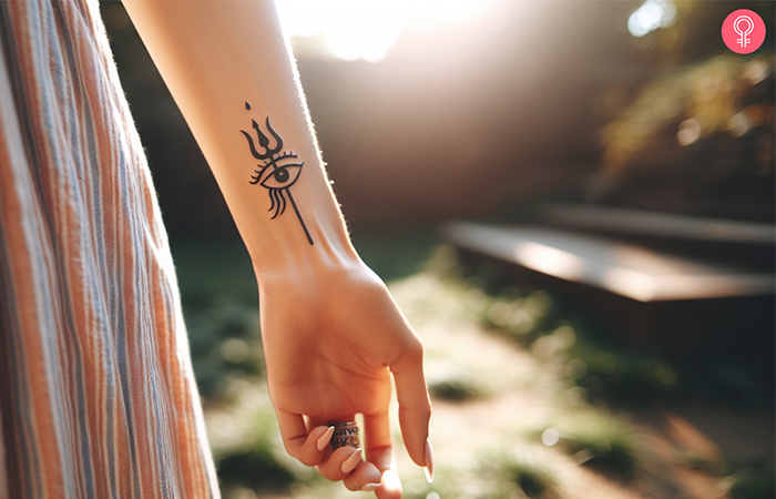 A woman with a Shiva third eye tattoo on her wrist