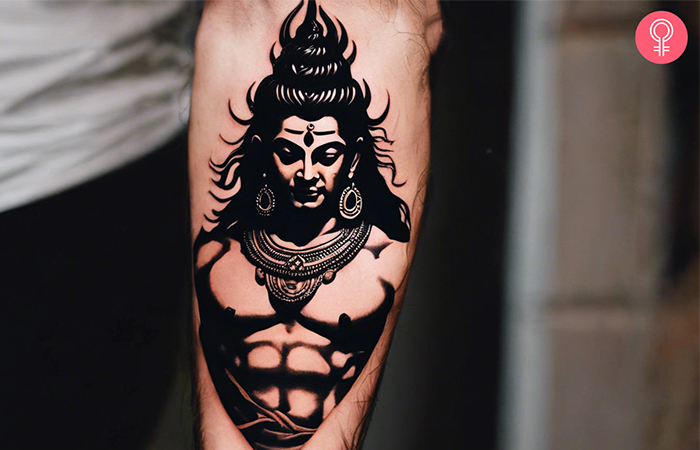 A man with a Shiva tattoo on his forearm