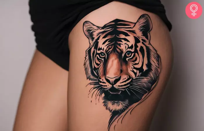 Woman with a tiger tattoo on the side thigh