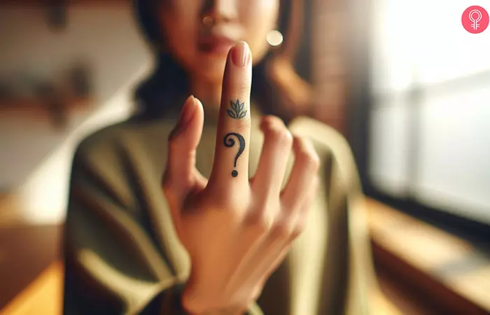 A single question mark tattoo on the finger of a woman