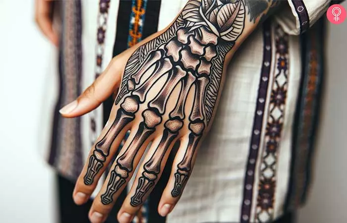 A skeleton hand tattoo on the back of a woman’s hand