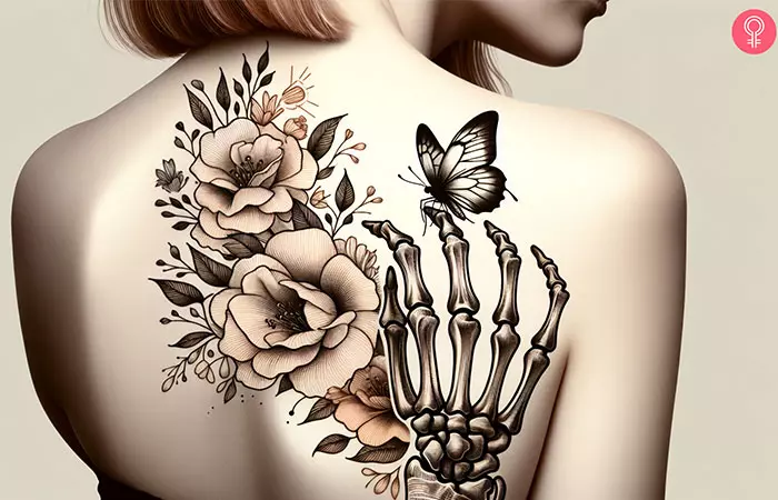 A woman with a butterfly and skeleton hand tattoo on her back