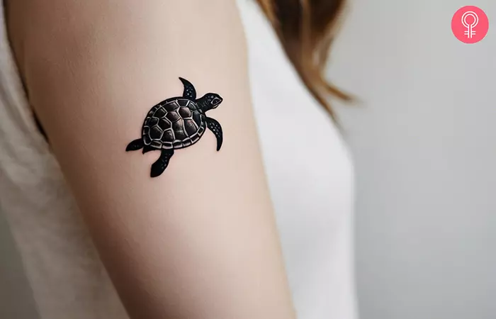 Small turtle tattoo on the upper arm
