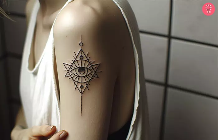 Spiritual eye tattoo on the arm of a woman
