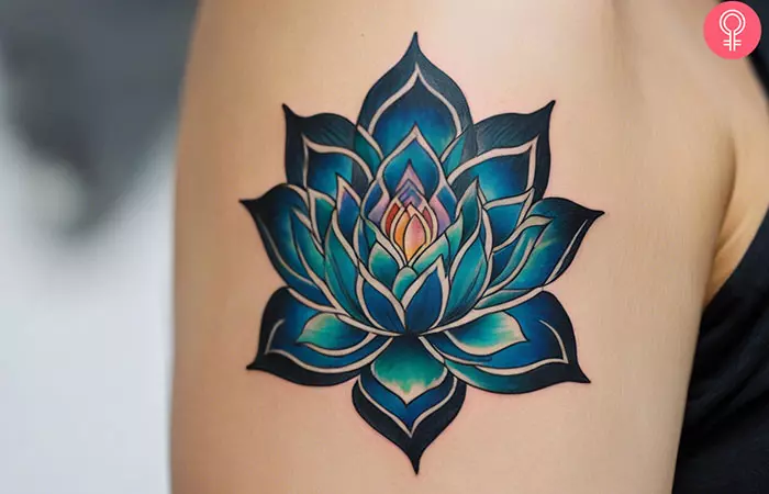 Spiritual lotus flower chakra tattoo on the upper arm of a woman