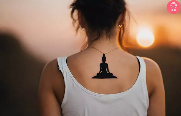 Spiritual meditation tattoo on the back of a woman