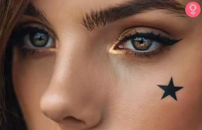 Star tattoo under the eye