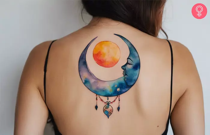 A woman with a sun and moon tattoo on her upper back