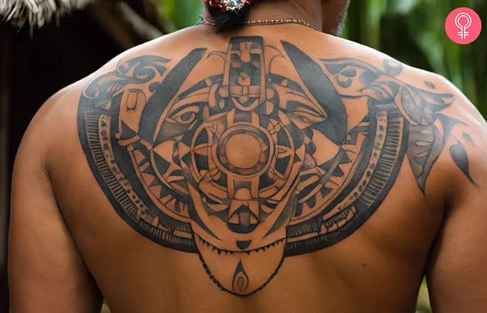 A man sporting a Taino back tattoo