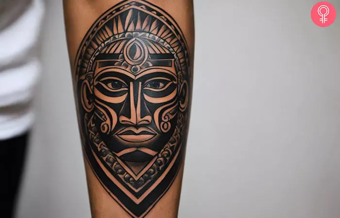 A man with a Taino tattoo on his forearm