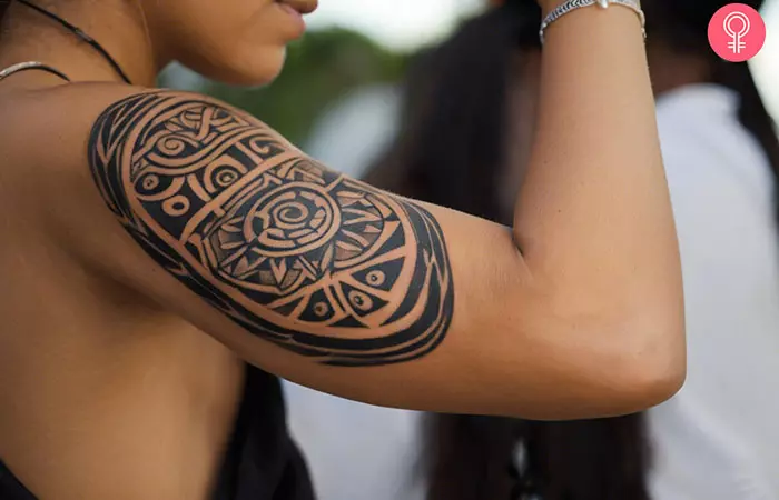 A woman with a Taino tribal tattoo design on her upper arm