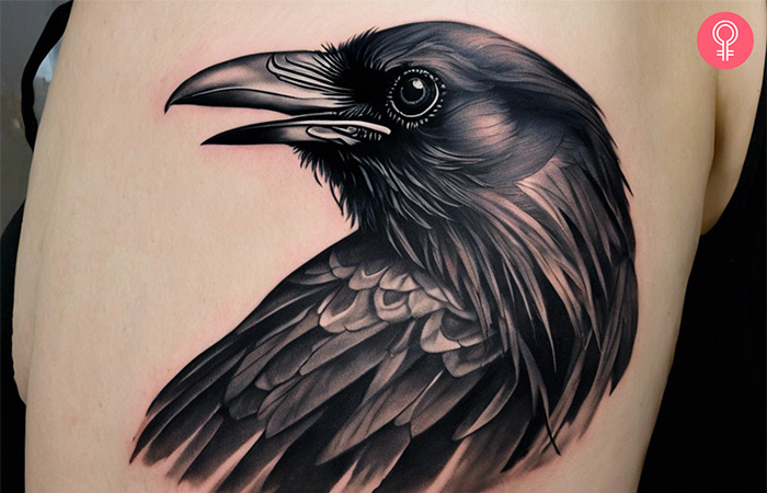 The head of a raven on the arm of a woman
