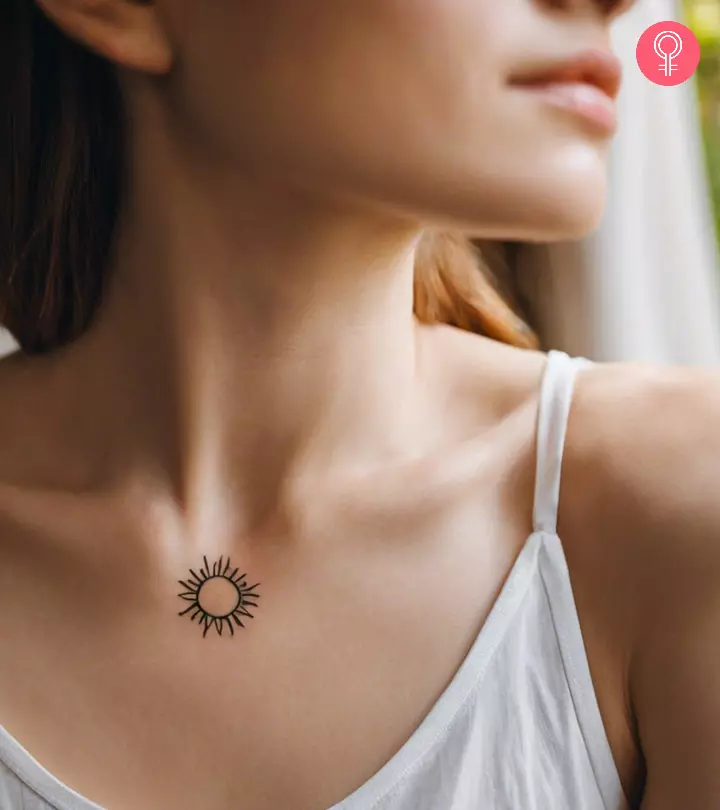 A woman flaunting a small sun protection tattoo on her chest