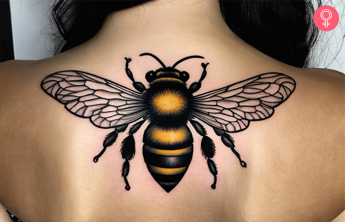 A large bumble tattoo on the upper back