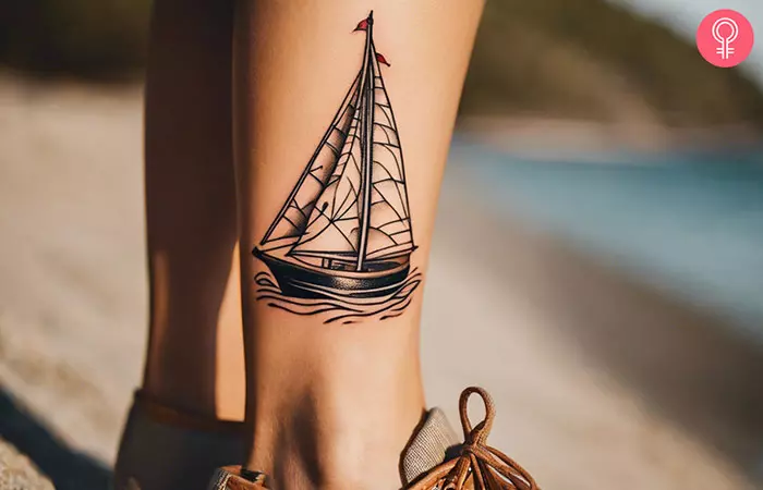 Woman with traditional sailboat tattoo on her ankle