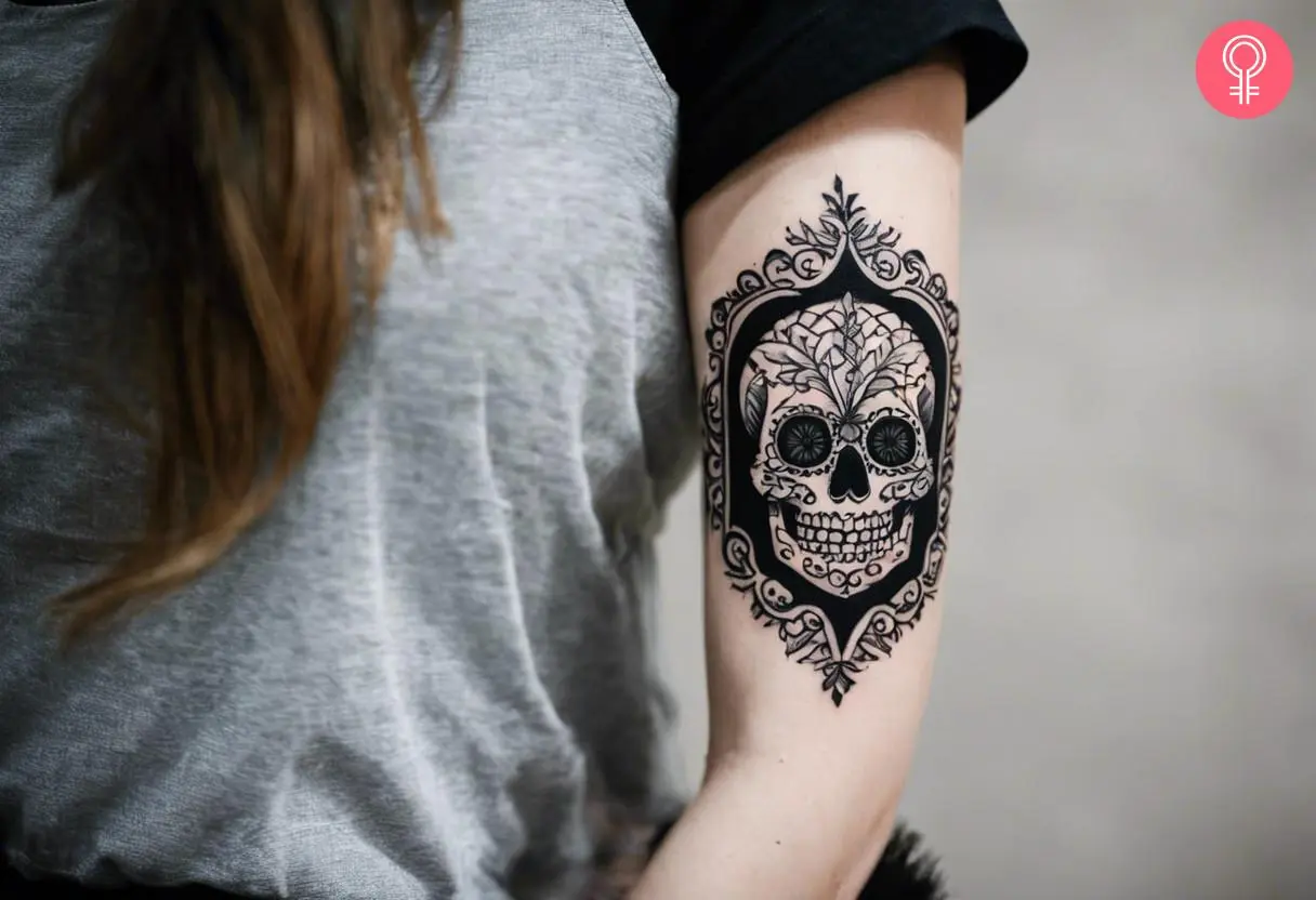 Traditional blackwork skull tattoo on the arm