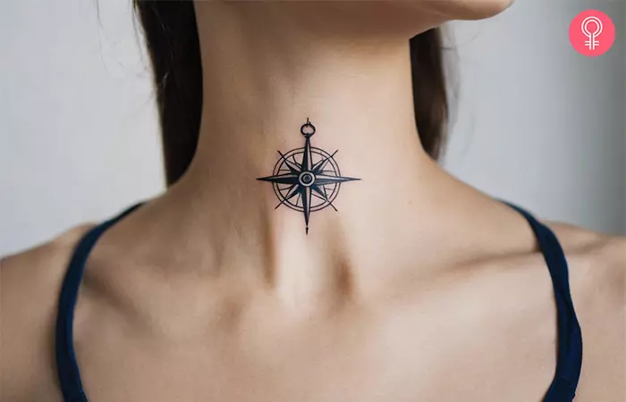 Travel tattoo of a sailor’s compass on a woman’s neck