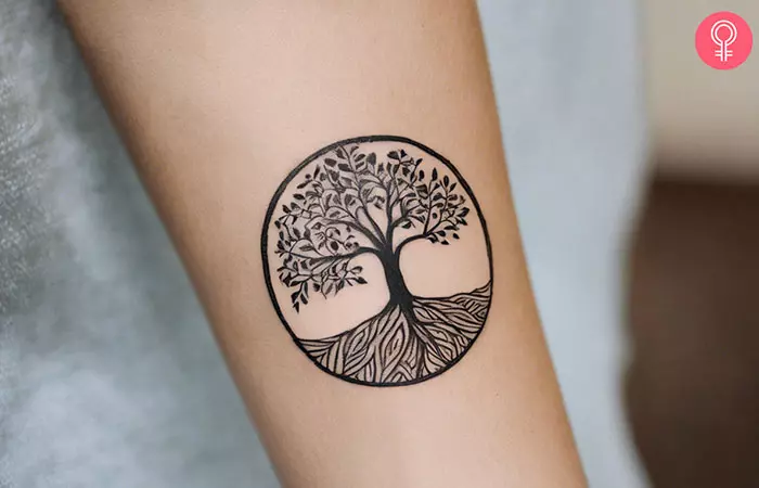 A tree of life forearm tattoo on a woman