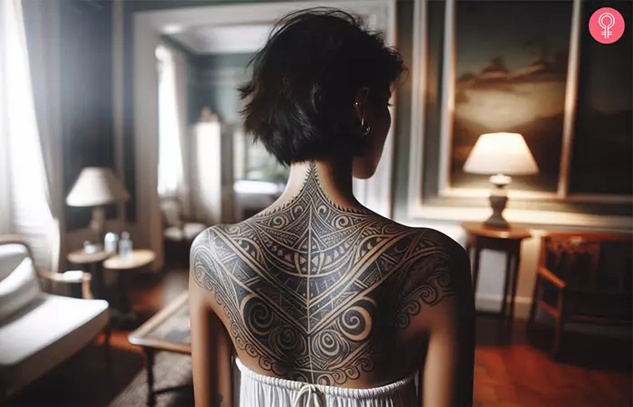 A woman with a tribal design tattoo on the back