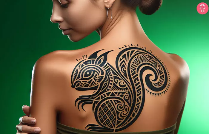 A tribal squirrel tattoo on the back