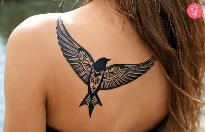 Tribal swallow tattoo on the back shoulder