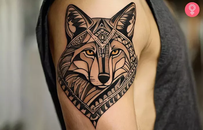 Tribal coyote tattoo on a man’s arm