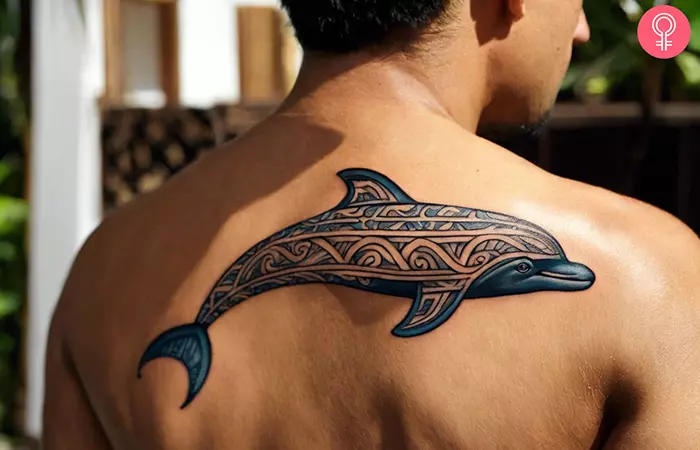 Tribal dolphin tattoo on the back