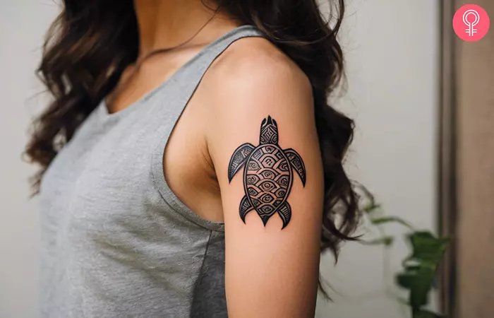 Tribal turtle tattoo on the upper arm