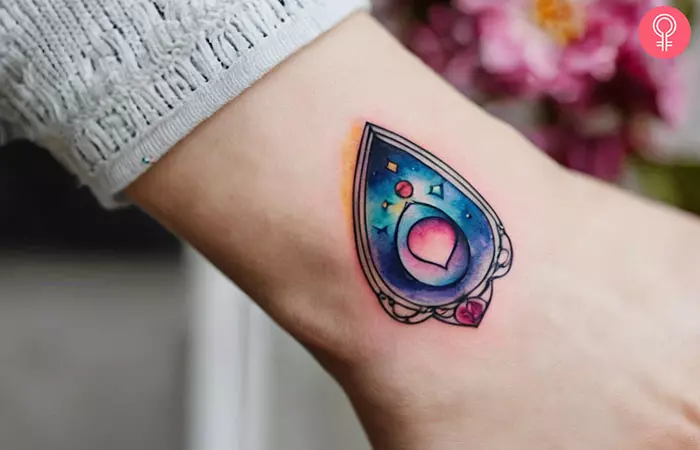 Vibrant planchette tattoo on a woman’s wrist