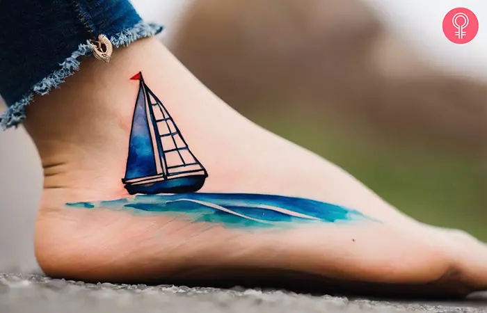 Woman with watercolor sailboat tattoo on her ankle