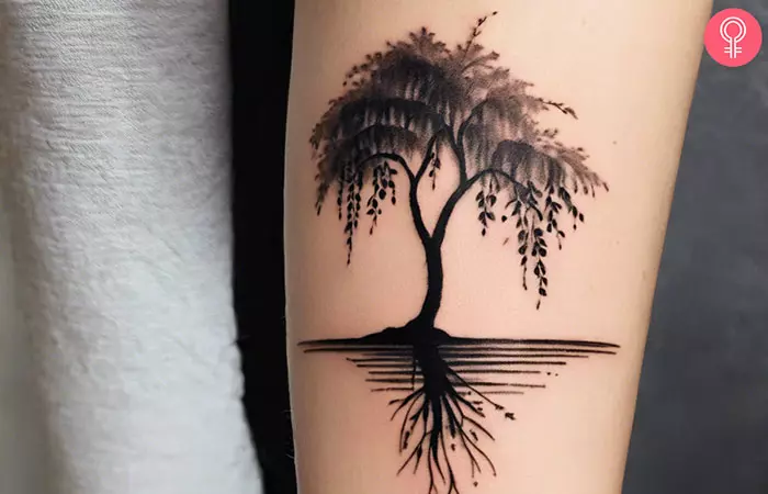 A willow tree forearm tattoo on a woman