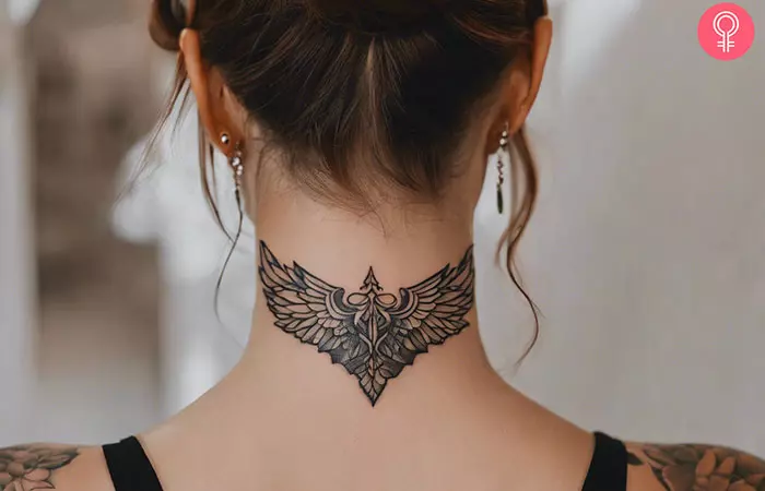Wings tattoo on the back of a woman’s neck