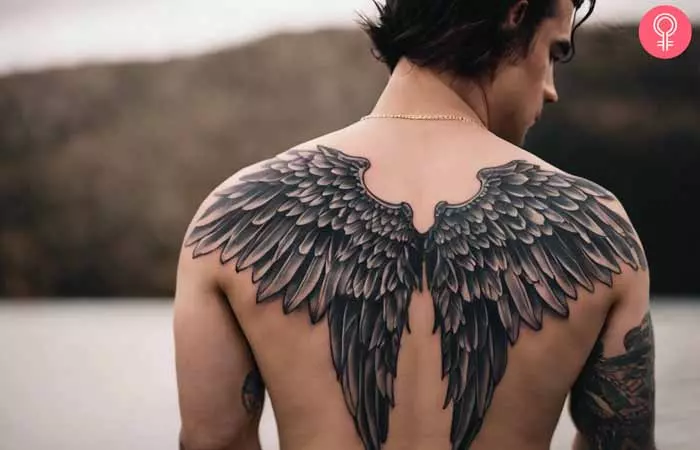  A man sporting a wings tattoo on the back