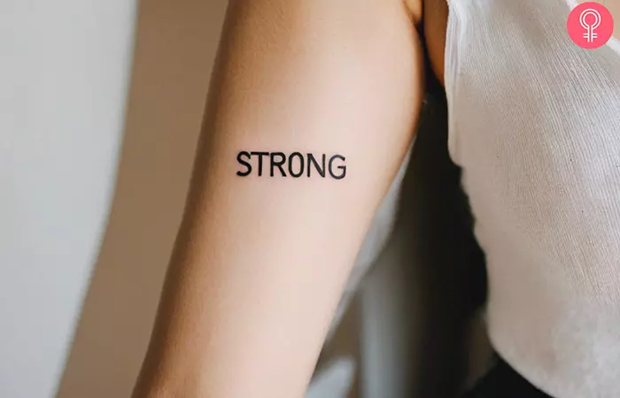 Woman with a ‘Strength’ tattoo on her upper arm