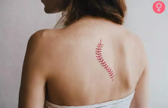 Woman with a baseball laces tattoo on the back