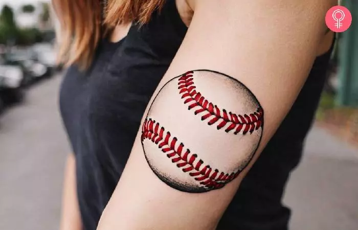 Woman with a baseball stitch tattoo on the forearm