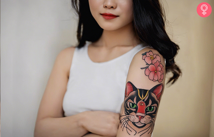 Woman with a good luck cat tattoo on her arm 