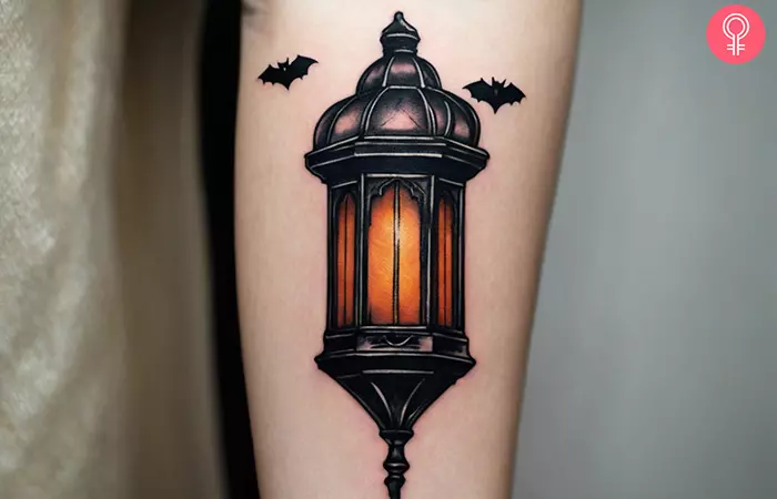 Woman with a gothic lantern tattoo on the forearm